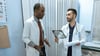  A Resident Doctor Speaking With An Attending Doctor
