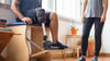 A Sitting Man Rehabilitating A Prosthetic Leg With The Help Of PM&R