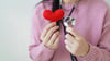 A Woman Holding A Heart And A Stethoscope