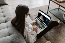 A woman looking at Radiology Reading Room on her laptop.