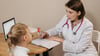 Family Medicine Doctor Speaking With A Child Patient