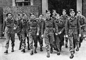 A black and white photograph of the first dozen med students who arrived at Bergen-Belson, led by Arnold Peter Meiklejohn