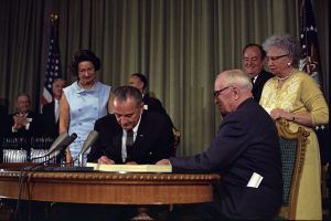 President Lyndon B. Johnson signing the Medicare Bill in 1965