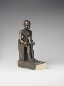A seated statue of Imhotep made of metal