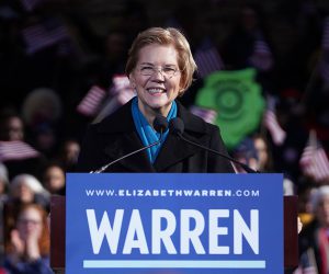 Elizabeth Warren speaking at a podium