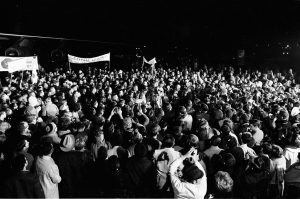 A black and white photograph of a crowd of people welcoming the crew of Apollo 8 back home