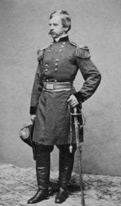 General Nathaniel Banks stands in his uniform, holding a hat in one hand and a sword in the other