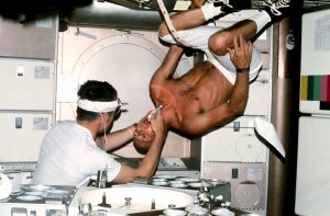 NASA astronaut Charles "Pete" Conrad, commander of the Skylab 2 mission, undergoes a dental exam by Medical Officer Joseph Kerwin in the Skylab Medical Facility.