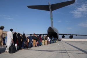 A long line of people waiting to board a plane