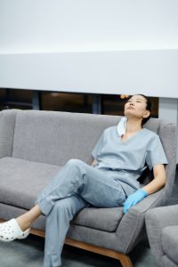 A female med student sitting back on a couch