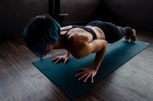 A person doing a plank on a yoga mat