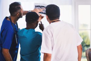 three people looking at an x-ray