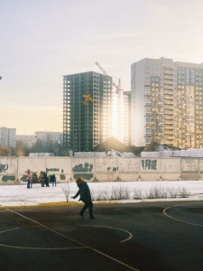 Kid Playing with an Airplane Toy in an urban setting