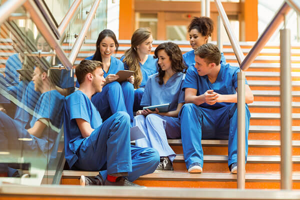 Medical students taking a break on the steps at the university