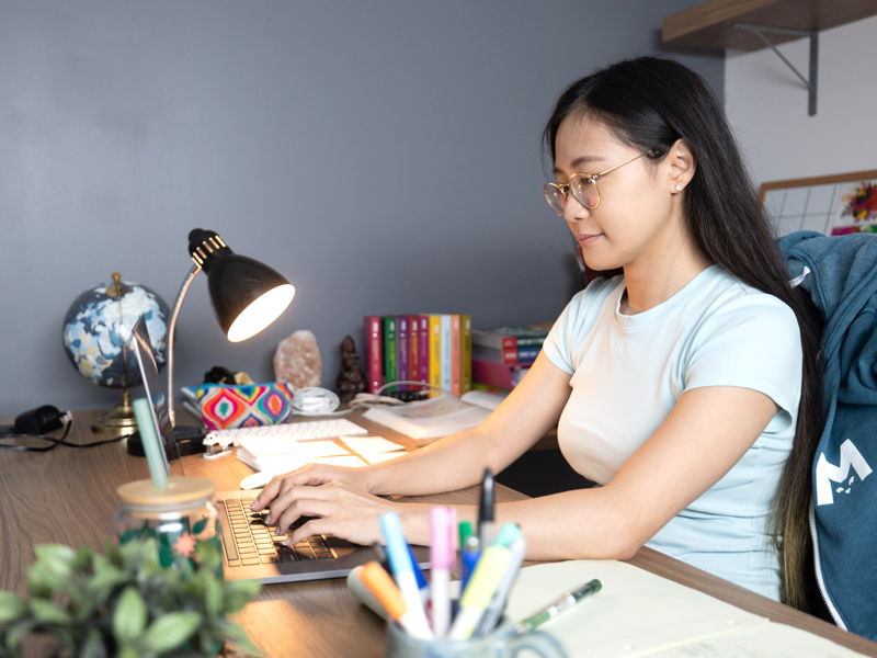 A female medical student studying at her laptop