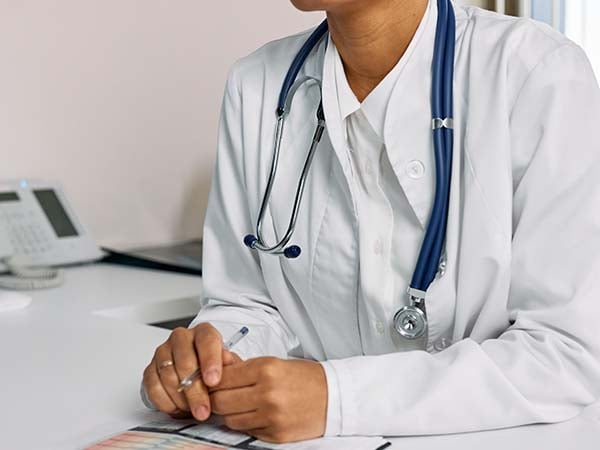 A doctor sitting at a desk